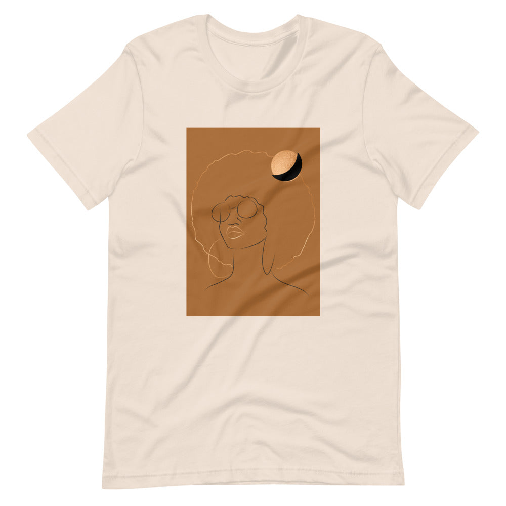Soft Cream, Tan Colored, t-shirt with a gold printed image  of a beautiful black women with an afro and a gold moon over her head